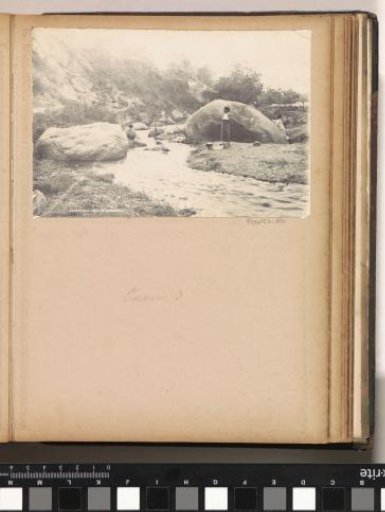 Women washing at rock formations on Ambon (possibly the Paper Elephant)