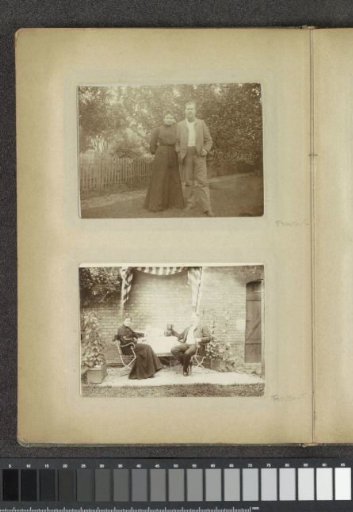 Portrait of a man, a woman and two dogs sitting at a table in a garden in Germany