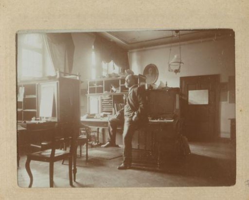 Portrait of a man sitting on a writing desk in an office in Germany