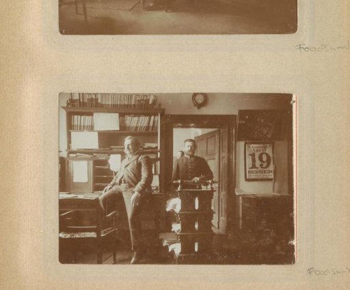 Portrait of a man sitting on a writing desk and a clerk with a cart in an office in Germany