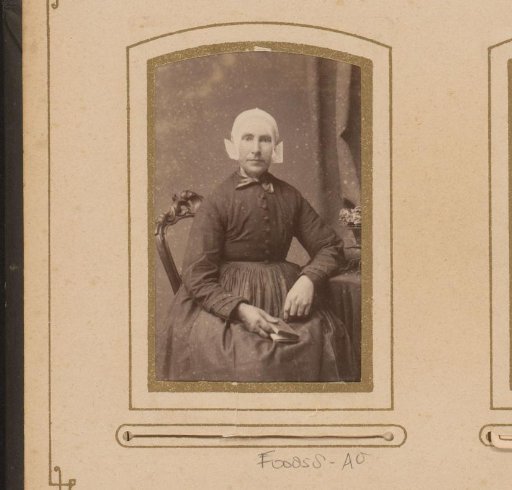 Portrait of a seated woman wearing a cap