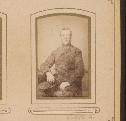 Portrait of a seated man with a beard