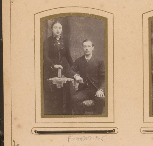 Portrait of a man and woman with a book at a table