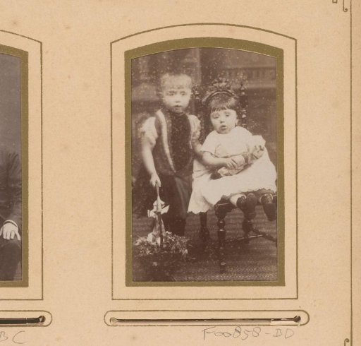 Portrait of two children with a doll and flower basket