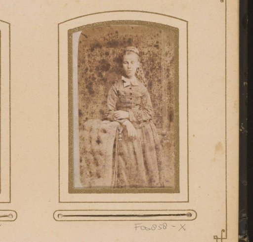 Portrait of a girl, standing by a chair