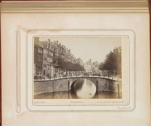 View of the Leidsegracht with a man with a handcart on a bridge in the foreground