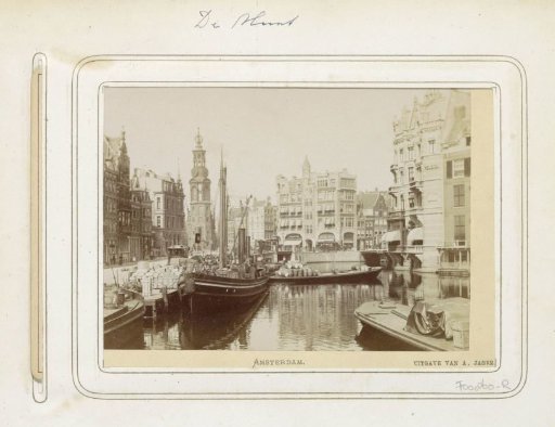 View of cargo boats on the Amstel with the Munttoren in the background
