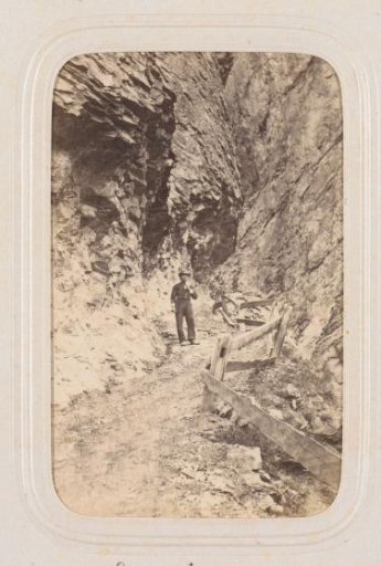 Hiker on a Path on the Gemmi Mountain in the Valais