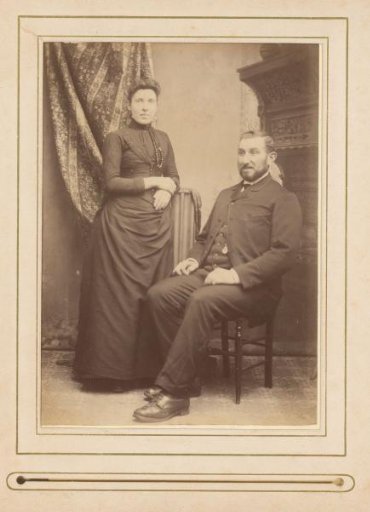 Portrait of a woman and a seated man