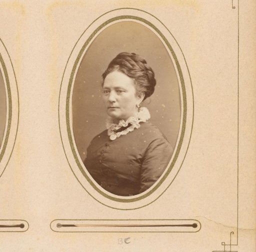 Portrait of a woman with a necklace featuring a medallion