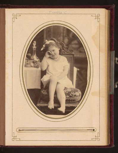 Portrait of a crying girl, seated on a chair