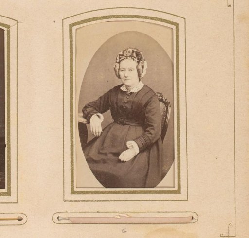 Portrait of a seated woman with a cap