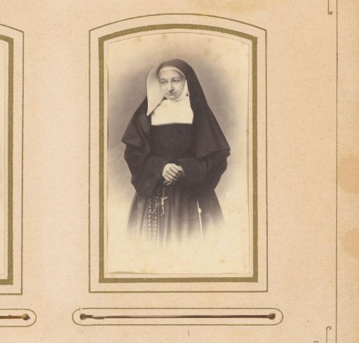 Portrait of a young nun with a rosary in her hand