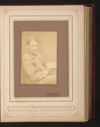 Portrait of a seated man with an open book in his hand