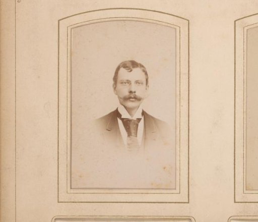Portrait of a man with a mustache and spectacles