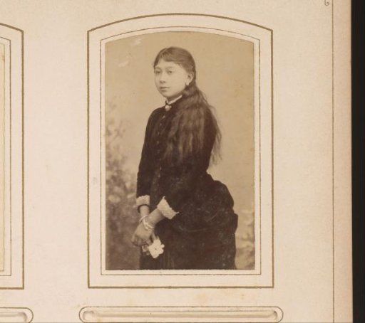 Portrait of a Girl in a Black Dress with a White Flower in Her Hand