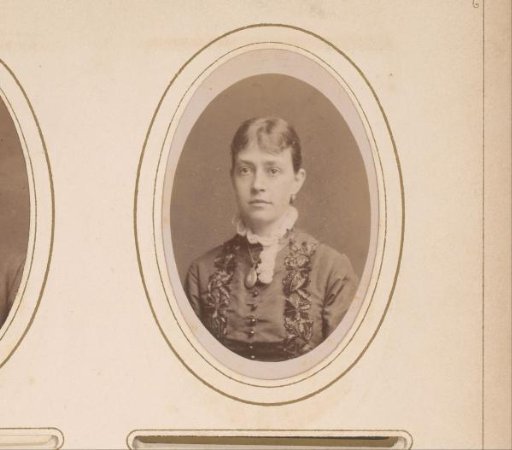 Portrait of a woman with earrings and a necklace with a medallion