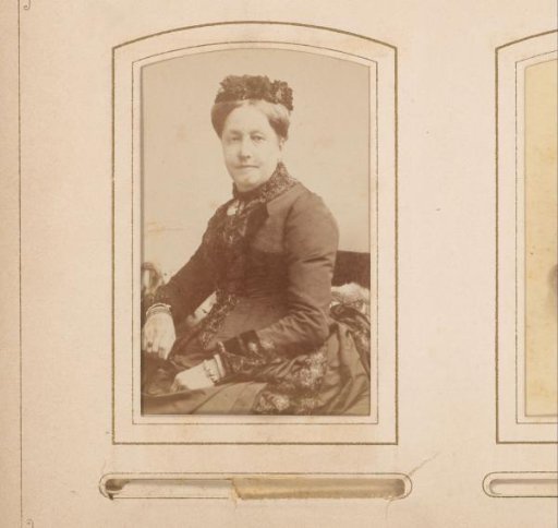 Portrait of a seated woman with a cap