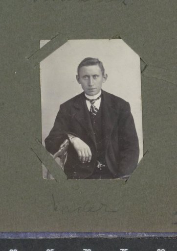 Portrait of a seated man with a striped tie, designated as 'Father'