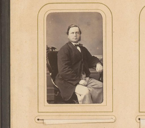 Portrait of a seated man with ring beard