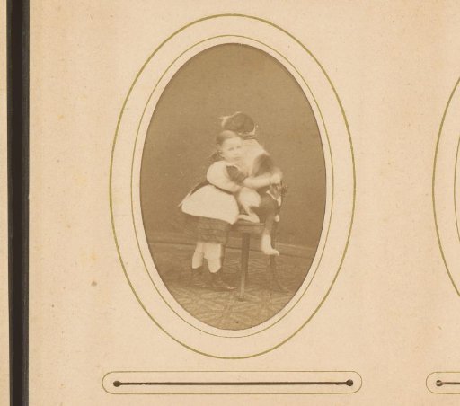 Portrait of a girl, identified as Adele Anne Remy, cuddling a dog on a chair