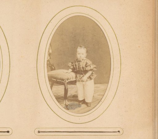 Portrait of a toddler, standing by a chair