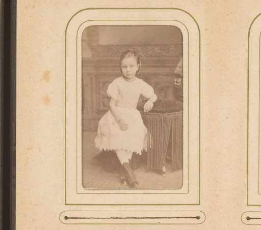 Portrait of a girl, standing by a table