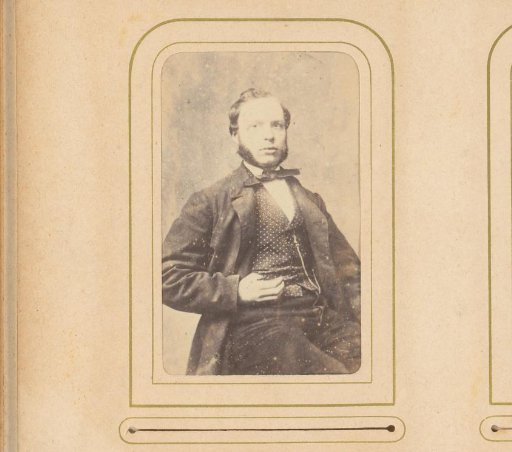 Portrait of a seated man with sideburns