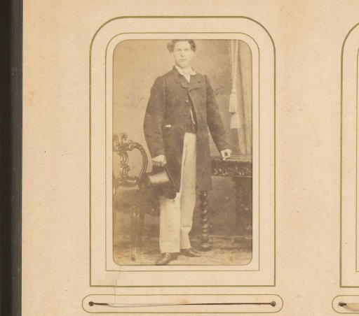 Portrait of a standing man with a top hat in his hand