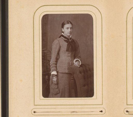 Portrait of a young woman, standing by a chair