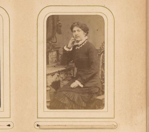 Portrait of a seated woman, leaning with her arm on a book