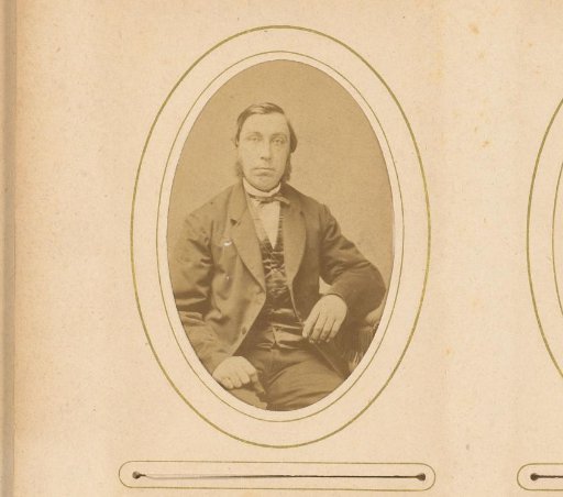 Portrait of a seated man with sideburns