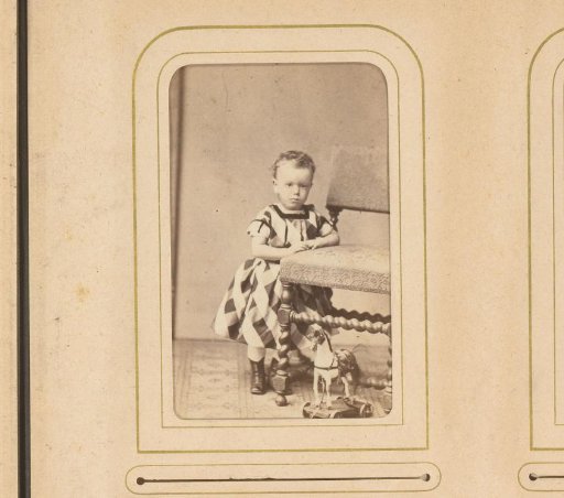 Portrait of a Girl Standing by a Chair and a Toy Horse
