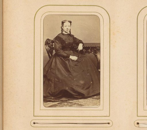 Portrait of a seated young woman with ringlets