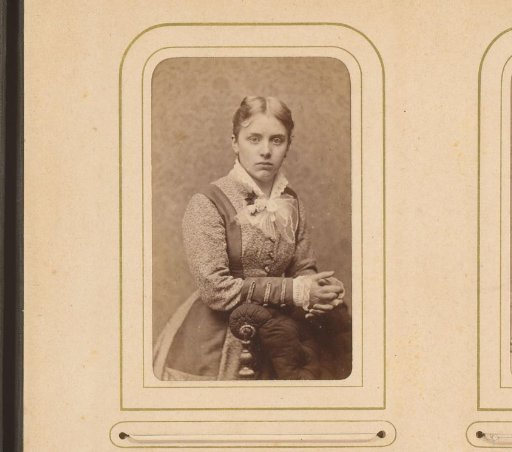 Portrait of a standing woman, leaning on the back of an armchair
