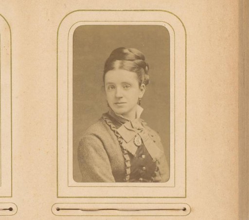 Portrait of a young woman with a necklace with a medallion