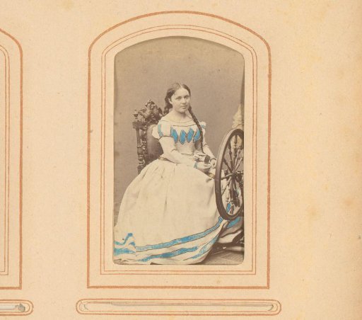 Portrait of a woman, seated by a spinning wheel