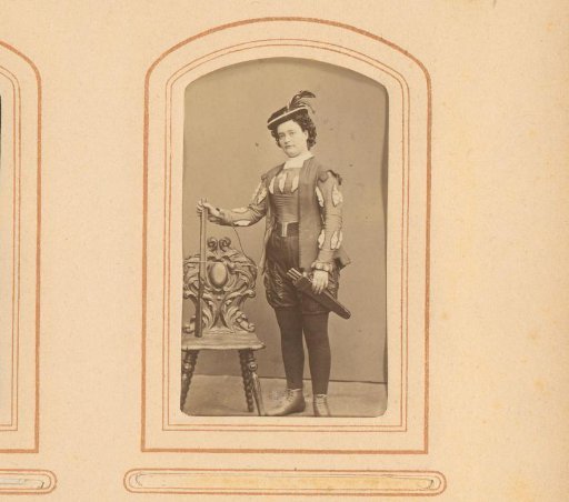 Portrait of Charlotte Strandberg, standing in theatrical costume with bow and arrow