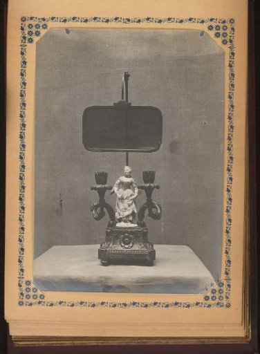 Candelabrum decorated with a sculpture of a woman and two flower calyxes