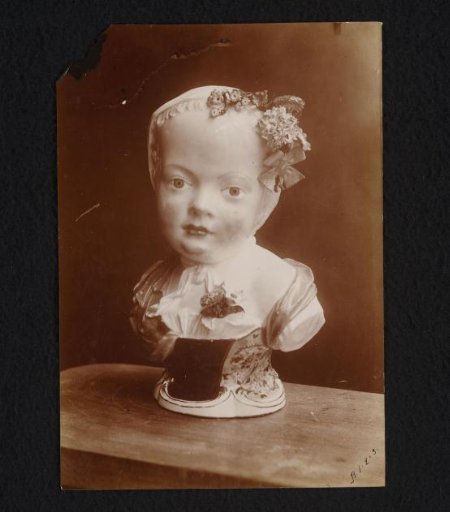 Porcelain bust of a girl wearing a cap