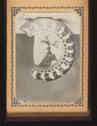 Part of a plate painted with a figure in profile
