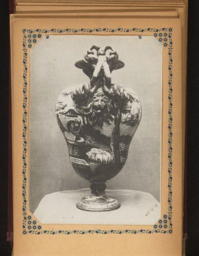 Vase decorated with a lion's head and painted with figures and animals