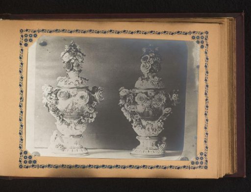 Two vases painted with a scene of courtesy and decorated with flowers