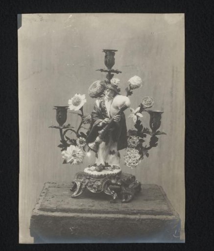 Candlestick decorated with a bagpiper