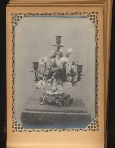 Candlestick decorated with a bagpiper