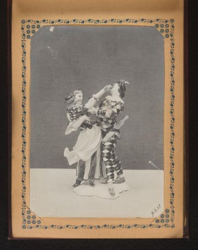 Sculpture of a man and a woman with a child in her arms, all in checkered clothing