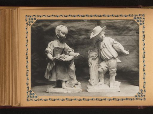 Sculpture of a girl with fruit in her apron and a sculpture of a boy