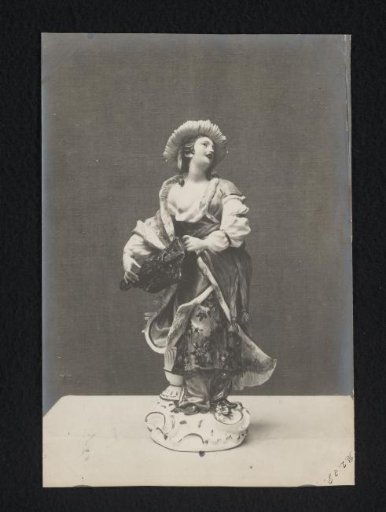 Sculpture of a woman holding an object