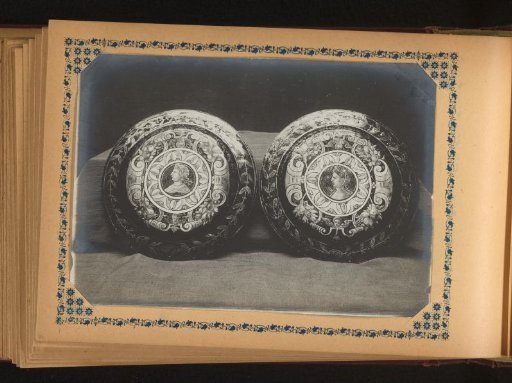 Two plates, painted with cherubs and a face and profile