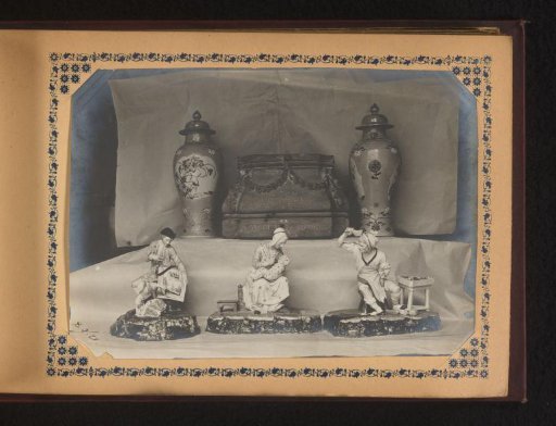 Three sculptures, two vases, and a pedestal with inscription